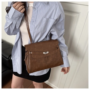 Brown vintage leather crossbody bag with metal buckle shown on a model for daily styling