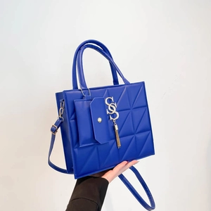 Bright blue quilted handbag with gold S-pendant, mini coin purse and shoulder strap