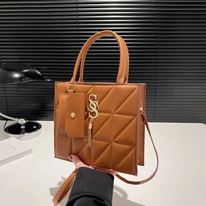 Brown quilted leather tote bag with gold S-logo and fringe tassel for casual use