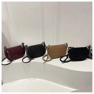 Showcase of four suede crescent crossbody bags in burgundy, grey, khaki and black