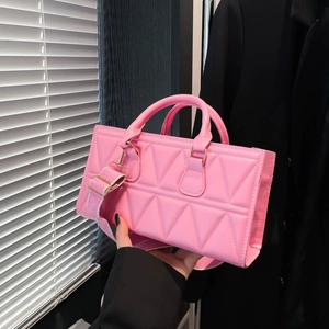 Pink rectangular tote bag with geometric triangle stitching and adjustable shoulder strap