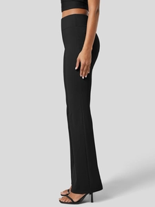 Side view of high-waisted black yoga flare pants highlighting the slim fit and leg curve