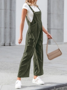 Detailed texture of dark green corduroy jumpsuits with adjustable straps and front pocket