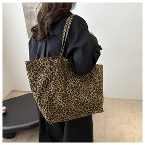 Close-up of leopard print tote bag with long straps and spacious trapezoid structure
