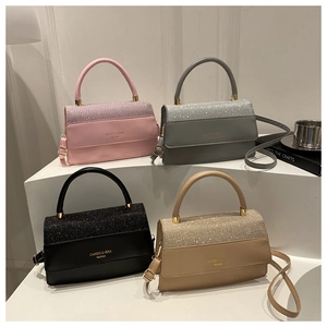 Detail view of stylish square handbags in pink, grey, black and khaki with glitter finish