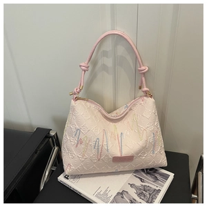 Detail of colorful wavy embroidery and FASHION metal plate on beige tote bag