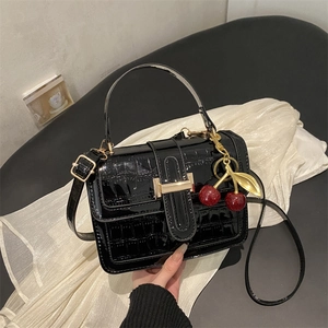 Glossy black crocodile pattern handbag with cherry charm and gold metal buckle