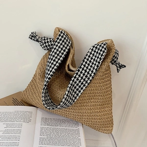 Handwoven straw tote bag with houndstooth patterned knot straps and spacious interior