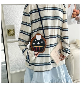 Chic black ice cream cupcake crossbody bag worn by a model in a casual outdoor setting