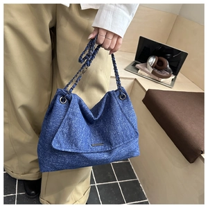 Detailed blue denim texture shoulder bag with stylish chain strap and metal decor