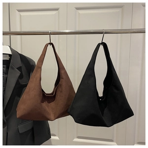 Detail view of premium matte suede shoulder bags in caramel brown and classic black colors