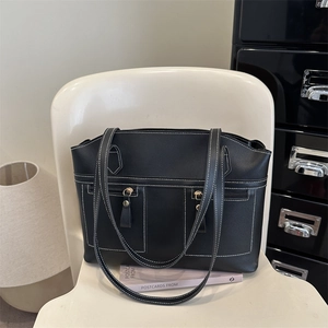 Retro black faux leather tote bag with white contrast stitching and zipper pockets