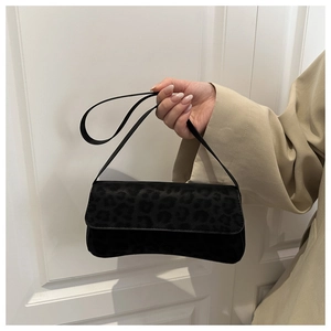 Close-up of black leopard embossed shoulder bag with slim strap and rectangle design