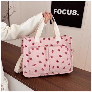 Pink corduroy tote bag with strawberry prints and dual front pockets detail