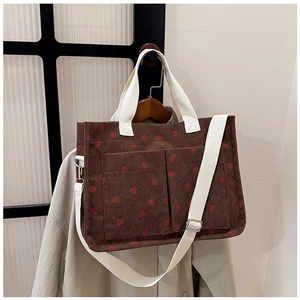 Brown corduroy tote bag with strawberry print and two front pockets detail