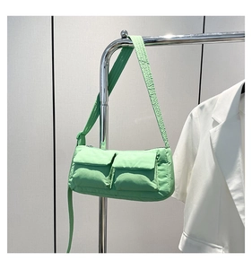 Detail of mint green quilted nylon crossbody bag with dual utility cargo pockets