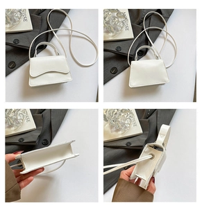 Detailed views of a minimalist white leather handbag with wave-flap and crossbody strap