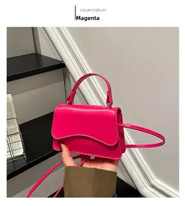 Detail of rose red glossy mini handbag with wavy flap and adjustable shoulder strap