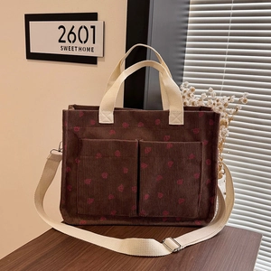 Brown corduroy tote bag with strawberry prints, dual front pockets and shoulder strap
