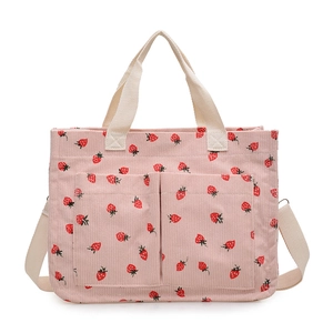 Pink corduroy tote bag with strawberry prints, dual front pockets and adjustable strap