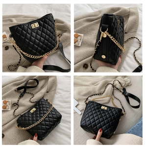 Macro detail of black quilted leather chain bag with golden rotating lock and metal hardware