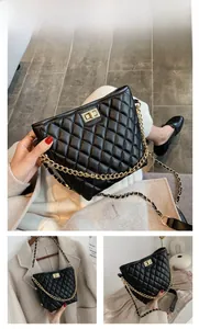 Detail of black quilted crossbody bag with golden twist lock and metal chain strap