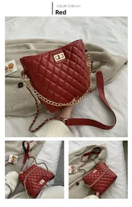 Detail of red quilted crossbody bag with gold chain strap and metal twist lock