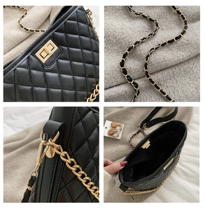 Macro detail of quilted leather texture, golden twist lock and chain strap on black bag