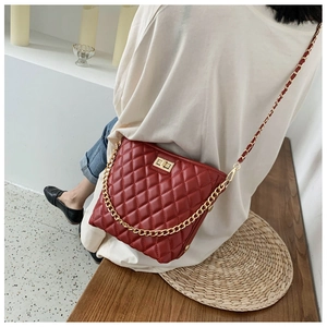 Classic red quilted crossbody bag with gold chain strap and metal turn-lock closure