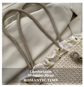 Detail of woven shoulder strap and sunflower lace on straw tote bag, romantic style
