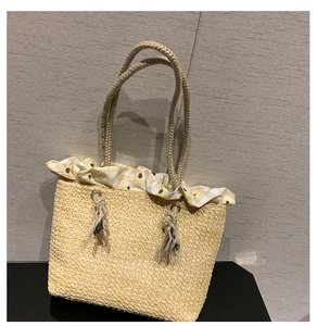 Close-up of straw woven tote with sunflower ruffles and braided rope handles