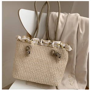 Detail of straw tote bag featuring sunflower decor and yellow gingham ruffle edge