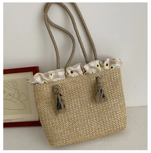 Detail of straw tote bag with daisy print lining and rustic hemp rope handles