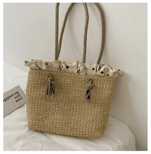 Detail of straw woven tote bag featuring sunflower print ruffles and twine handles