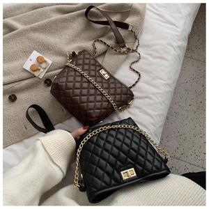 Detailed view of quilted chain crossbody bags in black and brown with metal twist locks
