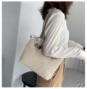 Detailed straw tote bag showing tight weave texture and daisy print drawstring lining