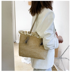Detail of straw woven tote bag featuring yellow sunflower floral drawstring lining