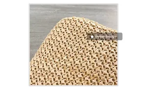 Macro shot of natural beige woven texture and intricate handmade straw bag patterns