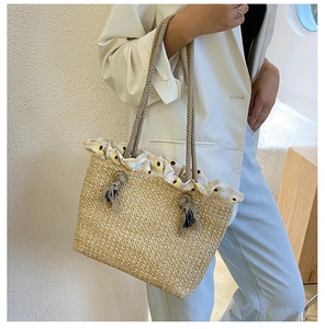 Close-up of straw woven tote with sunflower floral trim and braided rope handles