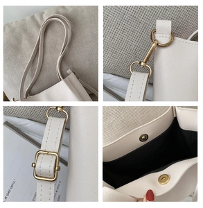 Detail view of cream tote bag with retro gold hardware and adjustable strap