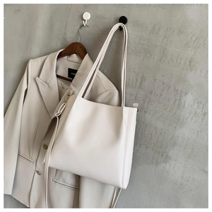 Minimalist white PU leather tote bag with gold metal hardware and slim shoulder straps
