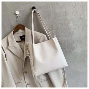 Detail view of large white tote bag in smooth matte finish with adjustable shoulder strap