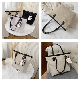 Detail of large canvas tote bag showing thick fabric texture and black leather handles