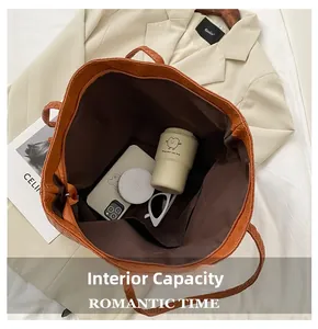 Internal view of orange woven tote bag showing large capacity with inner zipper pocket
