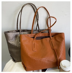 Detail of woven leather texture on grey and tan large capacity minimalist tote bags