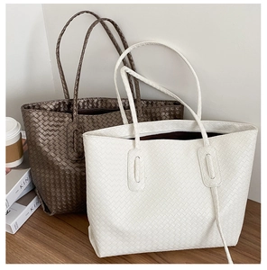 Detailed close-up of woven tote bags featuring intricate Intrecciato pattern and dual straps