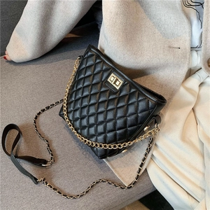 Classic black quilted crossbody bag with gold chain strap and metal turn-lock closure