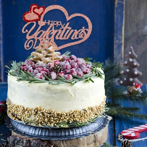 Rose gold glitter Valentine's Day cake topper featuring hearts on a frosted cake