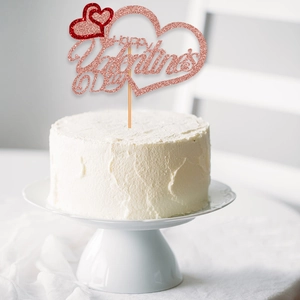 Close-up of pink glittery Happy Valentine's Day cake topper with two hearts on a cake