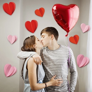 Romantic scene of 3D heart paper wall decals and red foil balloons for Valentines Day decor
